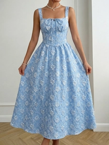 Detail of light blue floral jacquard dress showing square neck and bow tie decor