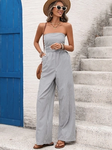 Close-up of black and white vertical striped strapless jumpsuit with high waist