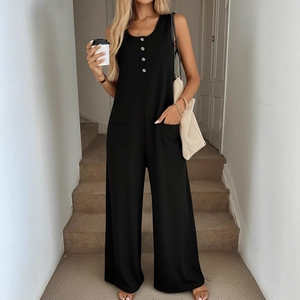 Women's black sleeveless wide leg jumpsuit with waffle texture and button detail