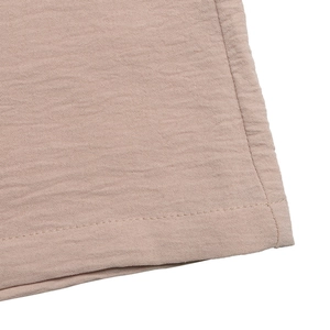 Close-up of pink casual jumpsuit fabric showing detailed stitching and waffle texture