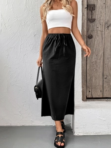 Detail of high waist black maxi skirt with elastic drawstring waistband and linen texture