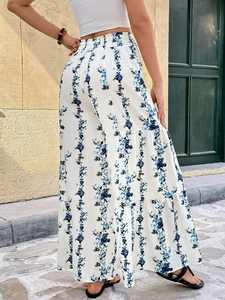Detail of high waisted floral wide leg trousers with tiered ruffle layers for women