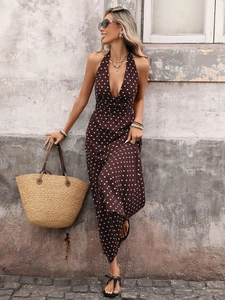 Detail of brown polka dot halter maxi dress with deep V-neck and flowing hemline