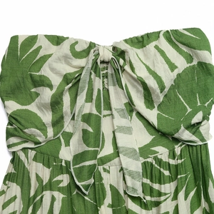 Detail of tropical leaf print tube top featuring a front tie bow and natural cotton texture