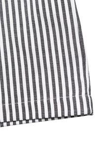 Close-up of black and white striped fabric texture with neat stitching on the jumpsuit