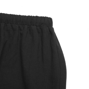 Close-up detail of the elastic waistband and fine stitching on this black maxi skirt