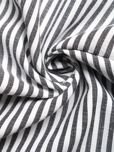 Detailed macro view of black and white striped fabric with soft cotton linen texture