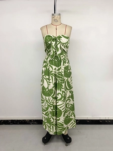 Detail of the oversized bow and green tropical leaf print on this strapless jumpsuit