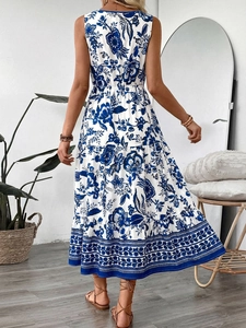 Detail of multi-tier floral print dress with geometric stripe hem and elastic waist