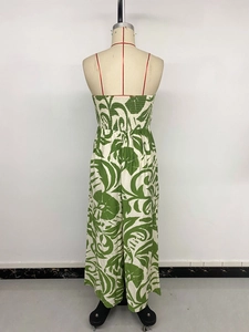Detailed back view of a strapless floral jumpsuit with green leaf print and wide legs