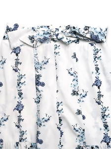 Detailed view of floral blue print on high waist fabric with a stylish bow tie detail