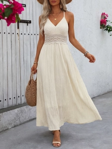 Detail of deep V-neck summer dress featuring intricate waist crochet lace and textured fabric