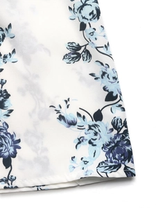 Detailed view of blue floral rose print on ivory high-waist wide-leg summer trousers