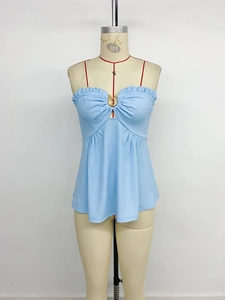 Detail of light blue seersucker tube top with ruffle trim and center gold metal buckle
