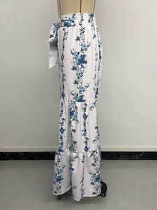 Detail of high waist bohemian skirt with blue floral print and tiered ruffle design