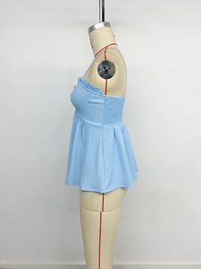 Close-up of light blue tube top featuring seersucker fabric and ruffled lettuce edge trim