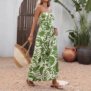 Elegant strapless jumpsuit with tropical green leaf print for a summer resort look