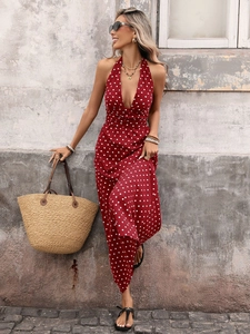 Detail of red and white polka dot halter maxi dress with a deep V-neck and cinched waist