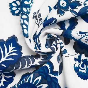 Close-up of elegant blue floral print fabric with twisted texture and soft drape detail