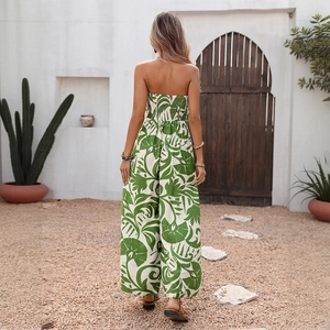 Back view of elegant green tropical leaf print strapless jumpsuit with wide leg pants
