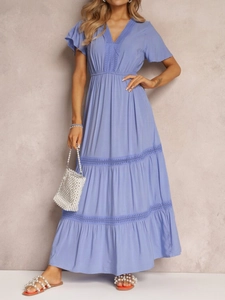 Detail of elegant light blue V-neck dress with lace hem and tiered ruffle sleeves