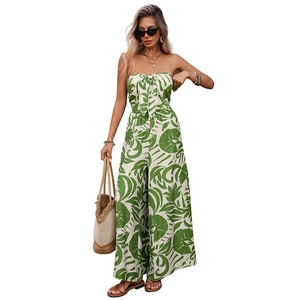Elegant tropical leaf print strapless jumpsuit with bow tied waist and wide leg fit