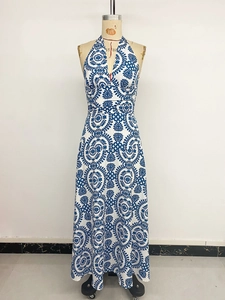Detailed pattern of blue floral print on white bohemian halter maxi dress on mannequin