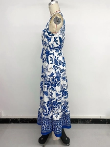 Detailed side view of vintage blue and white floral maxi dress with tiered skirt