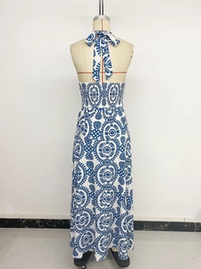 Detail of bohemian halter neck dress with smocked back and geometric floral print