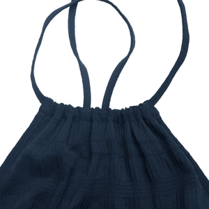 Detail view of navy halter dress neck with delicate pleats and linen texture