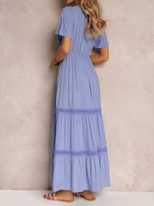 Detail of light blue tiered dress with crochet lace trim and elastic waist structure