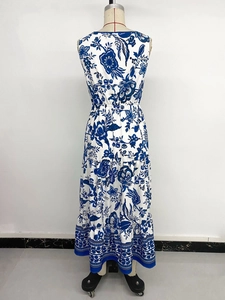 Detail of bohemian tiered maxi dress featuring blue floral print and elastic waist