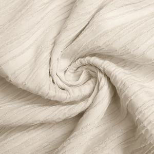 Detail shot of ivory summer halter dress fabric with vertical seersucker texture