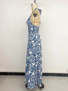 Detail of floral print and elastic waist on backless halter neck summer beach dress