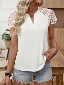 Detail of white V-neck T-shirt with intricate lace crochet sleeves and elegant fit