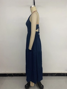 Detail of navy blue tiered halter maxi dress showing back tie and layered skirt design