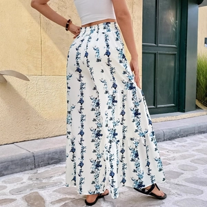 High waisted white bohemian wide leg trousers with blue floral print and tiered design