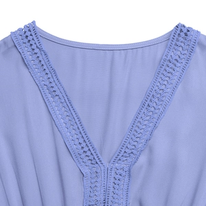 Close-up of elegant V-neckline with intricate crochet lace trim on a light blue dress