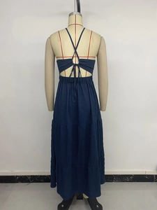Detail of cross back straps and tiered skirt design on a dark blue summer maxi dress