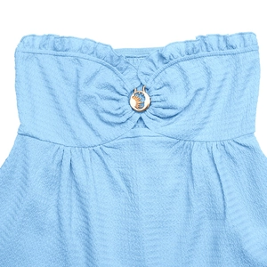 Detailed macro view of light blue ruched fabric featuring a golden sun and moon buckle