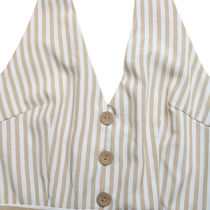 Macro view of striped halter neckline with three decorative wood-style buttons