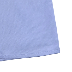 Detail of light blue twill fabric with neat single-needle stitching on the dress hem