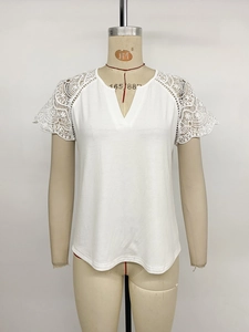 Close-up of women's white V-neck T-shirt showing intricate crochet lace sleeve details