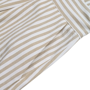 Detailed view of the striped fabric texture and functional side pocket on the romper