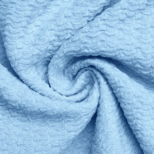 Macro texture view of light blue seersucker fabric with wavy seersucker patterns