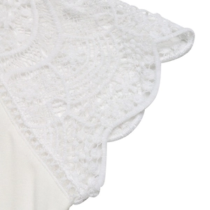 Close-up of white crochet lace trim and scalloped edges on a summer vacation V-neck T-shirt