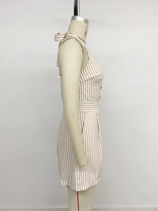 Side view detail of halter neck striped romper featuring waist tie and bow knot