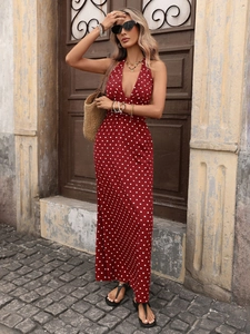 Detail view of red polka dot halter maxi dress with deep V-neck and backless design