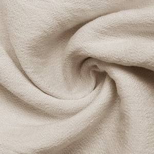 Close-up of elegant light beige fabric texture with soft drapes and fine plain weave details