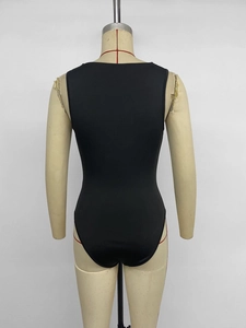 Detail view of the black sleeveless bodysuit showing the tight fit and back silhouette
